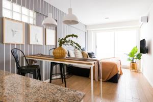 a living room with a bed and a table at Top Rentals Palermo Chico in Buenos Aires