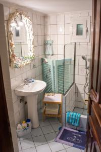 a bathroom with a sink and a shower and a mirror at Sofia's House in Paleo Tsifliki +18 photos