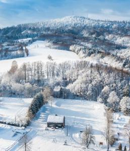 a truck parked in a field covered in snow at Rezydencja Bieszczady - Solina in Solina