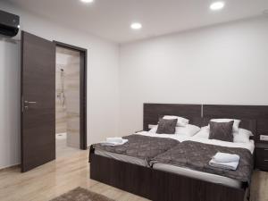 A bed or beds in a room at Andoravendégház - Villány