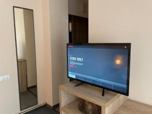 a flat screen tv sitting on top of a wooden stand at Casa Iulian in Cavnic