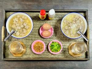 a tray of food with eggs and other ingredients at ดีต่อใจ รีสอร์ท เชียงม่วน Deetorjai Resort in Chiang Muan