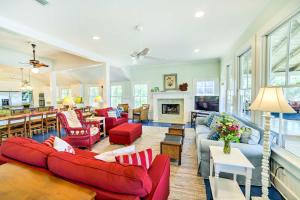 a living room with red furniture and a fireplace at Waterfront Perdido Beach House with Canoes and Kayaks! in Perdido Beach