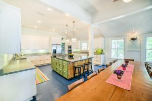a large kitchen with a large wooden table and chairs at Waterfront Perdido Beach House with Canoes and Kayaks! in Perdido Beach