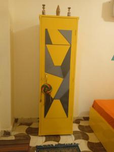 a yellow door with a tie inside of a room at NiLe ViEW RANA NUbian Guest HOUES in Aswan +90 photos