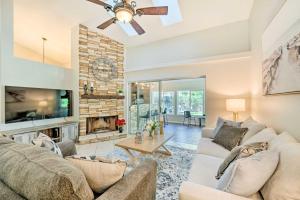 a living room with a couch and a fireplace at Pet-Friendly Central Florida Home with Pool! in Lake Mary