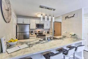 a kitchen with a large marble counter top with chairs at Lead Vacation Rental about 17 Mi to Sturgis in Lead