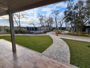 a patio with a walkway in a park at Monte Aromas in Roldán