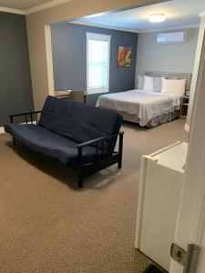 a bedroom with a bed and a couch in a room at Stanley House in Clarenville