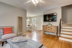 a living room with a couch and a flat screen tv at Exclusive Historical Townhome: serene and cozy in San Antonio
