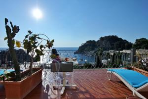 a balcony with a view of the ocean at Hotel Baia Azzurra in Taormina