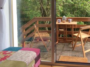 a balcony with a table and a table at Druimbhan, 1 Railway Cottage, in Lochailort