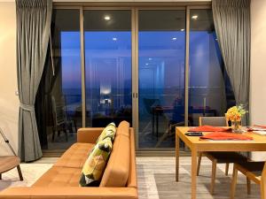 a living room with a couch and a table at Cosy seaview two bedrooms Nakula in North Pattaya +21 photos
