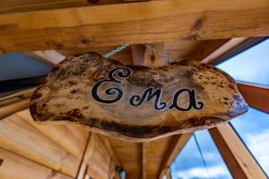 a sign that says ama hanging from a wooden ceiling at Vila Deniri in Zlatibor