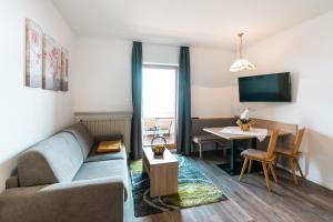 a living room with a couch and a table at Residence Innerfarmerhof in Tirolo