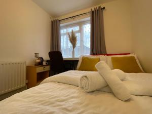 a bedroom with a bed with towels on it at Nice Living Serviced Accommodations 4 in Coventry