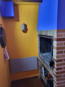 a living room with a fireplace with a blue ceiling at Casa Rural Reyes in Nuévalos