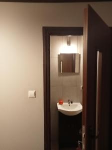a bathroom with a sink and a mirror at agroturystyka Pensjonat PAULA in Muszyna +20 photos