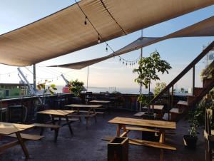 a row of tables and benches on a roof at Chante in Puerto Escondido