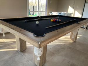 a pool table with two cuesticks on top of it at Monte Aromas in Roldán