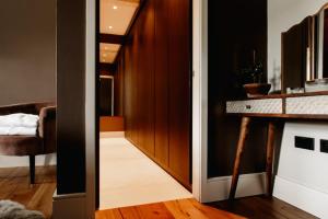 a hallway with a door leading to a living room at Luxury 4 Bed Dales Retreat Private Walled Garden All Ensuite Sleeps 8 SuperKing 1 Double 2 King 1 in Embsay