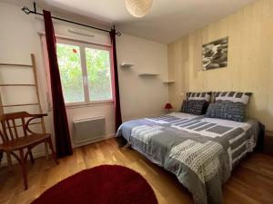 ein Schlafzimmer mit einem Bett und einem Fenster in der Unterkunft Jolie villa avec piscine à 6 kms des plages in Landevieille