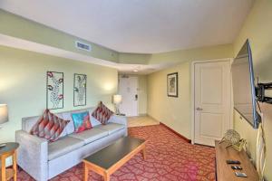 a living room with a couch and a table at Bayview Resort Penthouse w/ Sunset Views in Myrtle Beach