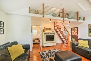 a living room with a couch and a loft at Modern St Elmo Cottage by Lookout Mtn and Near Dwtn in Chattanooga