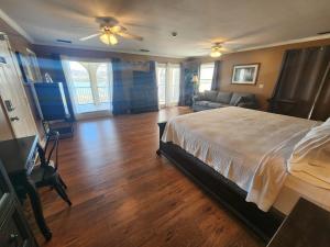 a bedroom with a large bed and a living room at Tennessee Room at Tennessee RiverPlace in Chattanooga