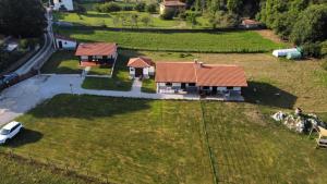 an aerial view of a house with a car in a field at El Llagar de Mon II in Llanes