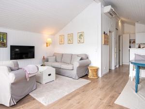 a living room with two couches and a tv at Holiday home Silkeborg XXI in Silkeborg