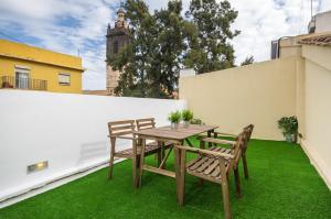 a table and chairs on a balcony with green grass at BET Apartments - Tramontana Apartments in Valencia