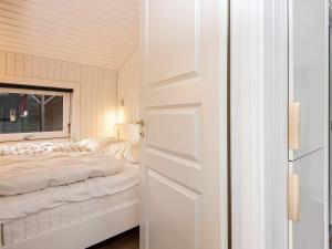 a bedroom with a white bed and a window at Holiday home Silkeborg XXI in Silkeborg
