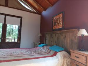 a bedroom with a large bed in a room with a window at Las Nenas. Un paraíso en el bosque in Mar Azul