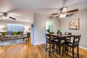 a dining room and living room with a table and chairs at Classy Mid-Century Townhome in Alamo Heights in San Antonio