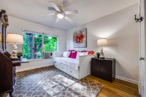 a living room with a white couch and a window at Classy Mid-Century Townhome in Alamo Heights in San Antonio