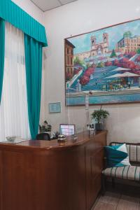 a court room with a desk and a large painting on the wall at Hotel Aristotele in Rome