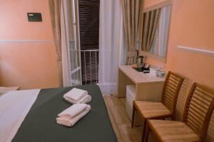 Postel nebo postele na pokoji v ubytování Hotel Aristotele