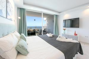 a bedroom with a large bed with a view of the ocean at SEA LA VIE Ponderosa 617 in Playa Fañabe