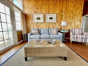 a living room with a couch and a coffee table at Key West Cottages in Chincoteague