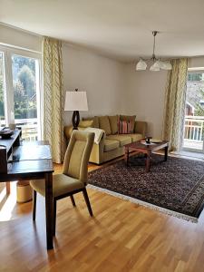 a living room with a couch and a table at Apartment Velden - Angelika Berginz in Velden am Wörthersee