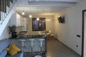 a kitchen and living room with a bar and a couch at CASA RURAL MENSIN in Vilar de Canes