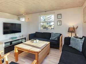 a living room with a couch and a table at 4 person holiday home in Hals-By Traum in Hals