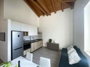 a kitchen with white cabinets and a table and chairs at Dimora il Fontanile in Castel di Guido