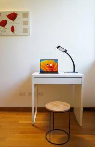 a white desk with a lamp and a laptop on it at Dimora il Fontanile in Castel di Guido