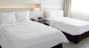 Postel nebo postele na pokoji v ubytování Sol de Oro Hotel & Suites