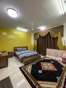 una camera con un letto e un tappeto sul pavimento di Cloudy Cloud Farm Resort a Izkī
