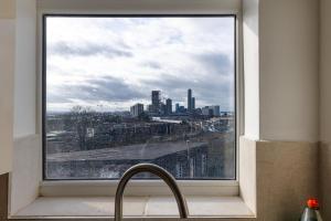 a kitchen window with a view of a city at Entire luxurious flat sleeps 4 persons in London