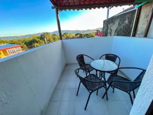 a balcony with a table and chairs on it at Casssa Vlanca Hotel in Palenque