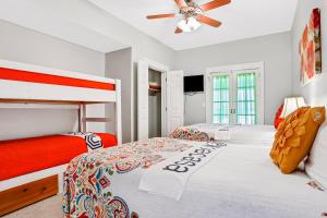 a bedroom with two bunk beds and a ceiling fan at Breaking Winds in Port Saint Joe